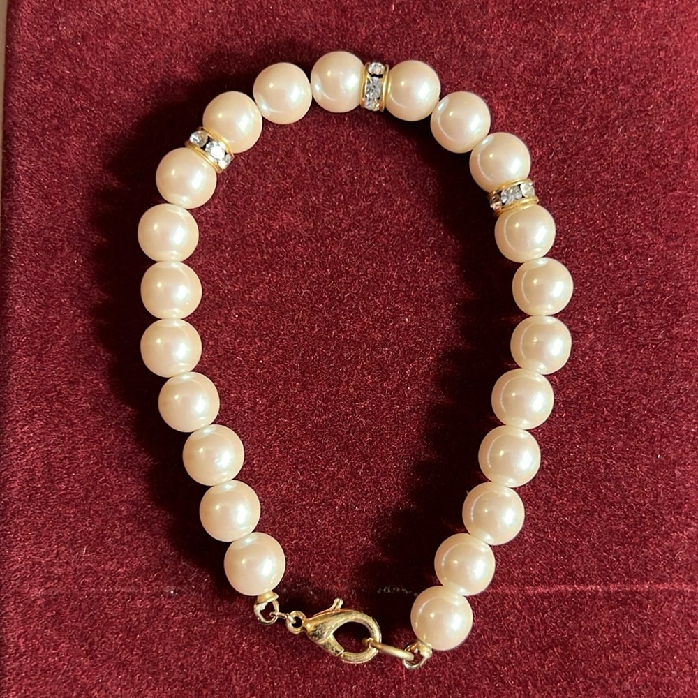Vintage Faux Ivory Pearl And Goldtoned Rhinestones Bracelet with lobster clasp.